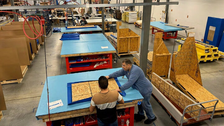 Bison workers in factory assembling equipment