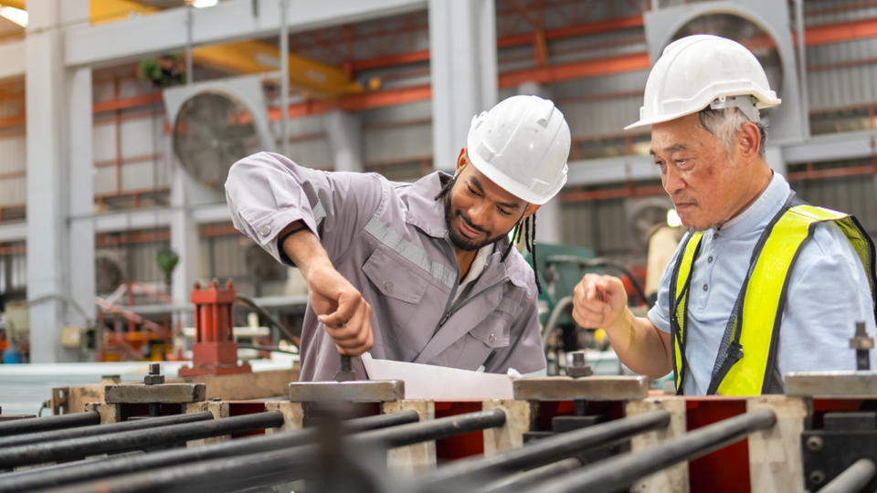 Two QA inspectors working production line.